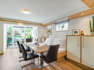 a dining room with a table and a couch at Studio Rupertus-5 by Interhome in Maishofen