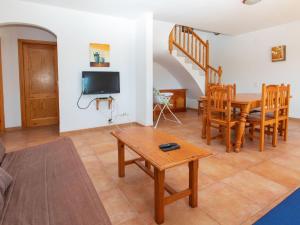 a living room with a table and a tv at Villa Villa Malva II by Interhome in Les tres Cales