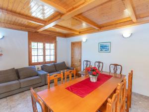 a living room with a wooden table and a couch at Villa Villa Palma by Interhome in Les tres Cales