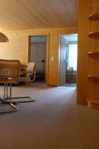 an empty room with a table and chairs in a building at Apartment Kronenplatz 6 # 2 by Interhome in Lenk
