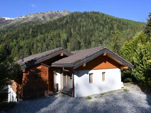 a house with a mountain in the background at Chalet Ropiar by Interhome in Ovronnaz