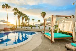 a resort pool with a swing and a swing bed at Haciendas Village Tenerife in Adeje