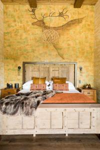 a bedroom with a large bed with a wooden headboard at Ancient Lore Village in Knoxville