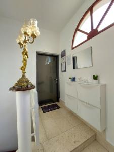 a hallway with a lamp on a pedestal in a room at Apartment Dalmatino in Split