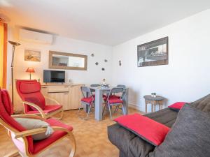 a living room with a couch and chairs and a table at Apartment Cap Sud-3 by Interhome in La Grande-Motte