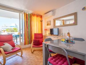 a kitchen and living room with a table and chairs at Apartment Cap Sud-3 by Interhome in La Grande-Motte +22 photos