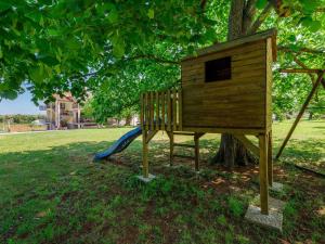 a wooden bird house on a tree in a park at Apartment Vesela-4 by Interhome in Savudrija
