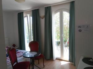 a room with a table and chairs and a sliding glass door at Ana Rooms in Krk