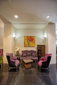 a living room with couches and chairs and a table at Hotel De Cerva in Cerva