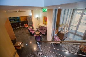 a view of a lobby with chairs and a bar at Hotel De Cerva in Cerva