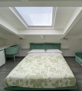 a bedroom with a bed and a skylight at Casa Lombardi in Santa Maria di Castellabate