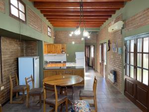 a kitchen with a table and chairs and a refrigerator at Casa calle Paula in San Juan