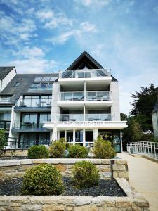a large white building with a lot of windows at Le Churchill Hôtel & Spa in Carnac