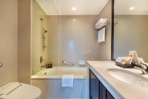 a bathroom with a tub and a sink and a toilet at Bandara Suites Silom, Bangkok - SHA Extra Plus in Bangkok