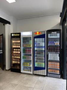 two refrigerators in a store with soda and drinks at Pension Alpha - Frankfurt City Central Station in Frankfurt