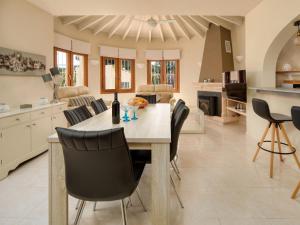 a kitchen with a wooden table and black chairs at Holiday Home La Cala by Interhome in Balcon del Mar
