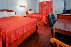 a hotel room with two beds and a desk at Route 66 Inn of Santa Rosa, NM in Santa Rosa
