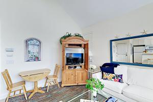 a living room with a white couch and a table at Cheery Retreat in Newport Beach