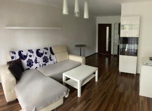a living room with a couch and a table at Byt Marie 10min to the square in České Budějovice