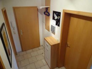 a bathroom with a door and a tile floor at Fewo Peenewiesen_SCHAe in Ostseebad Karlshagen