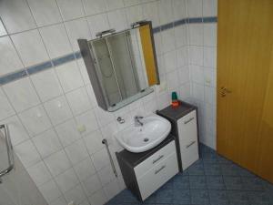 a bathroom with a sink and a mirror at Fewo Peenewiesen_SCHAe in Ostseebad Karlshagen