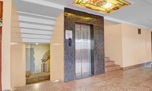 a lobby with a glass door in a building at Treebo Surya Yatri Niwas in Belgaum +27 photos