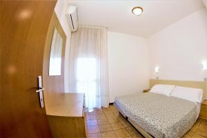 Posteľ alebo postele v izbe v ubytovaní Residence Columbia