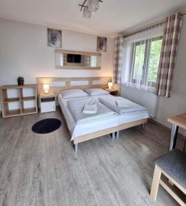 a bedroom with a large bed and a window at Pokoje Gościnne Nowa Grań in Zakopane