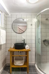 a bathroom with a sink and a mirror at Evangelia Residenza, elegant stay in Herakleion! in Heraklio Town