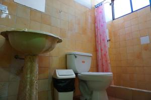 a bathroom with a sink and a toilet at Big Mountain Hostel in Huaraz