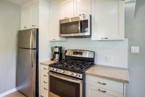 a kitchen with a stove and a microwave at Movie Colony Bungalow Permit# 3364 in Palm Springs