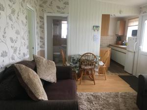 a living room with a couch and a kitchen at 313 Sundowner Holiday Park Hemsby in Hemsby