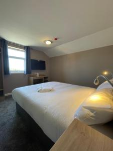 Postel nebo postele na pokoji v ubytování Tinapa Suites