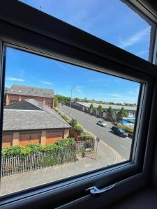 a window with a view of a street at Tinapa Suites in Manchester