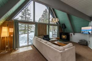 a living room with a couch and a large window at Arrowhead Escape in South Lake Tahoe