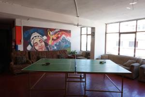 a living room with a ping pong table in it at Big Mountain Hostel in Huaraz