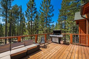 a deck with a couch and a grill at Marshall Escape in South Lake Tahoe