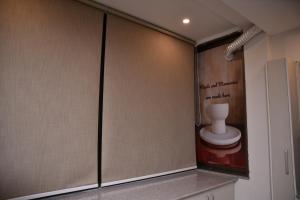 Łazienka z przesuwnymi drzwiami i toaletą na ścianie w obiekcie The Bliss w mieście Rawalpindi
