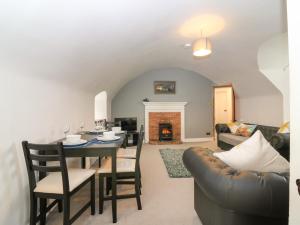 a living room with a table and a couch at East Wing - Castle Fraser in Inverurie