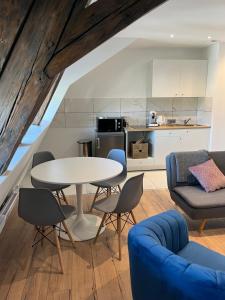a kitchen and a living room with a table and chairs at Le Gutenberg in Strasbourg