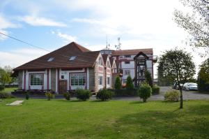 a house with a green lawn in front of it at Famozclub in Bakov nad Jizerou