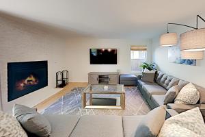 a living room with a couch and a fireplace at Summer Oasis in Windsor