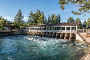 a dam on a river with water rushing through it at Cabin Oasis in Tahoma