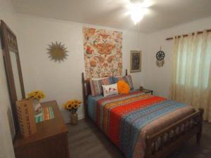 a bedroom with a bed and a dresser in it at Welcome to Pineapple House! in Pensacola