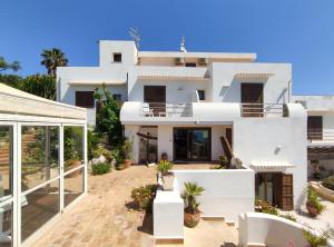 a white villa with a courtyard in front of it at La Rosa Sul Mare in Syracuse