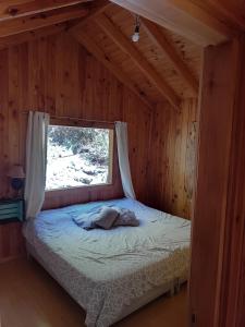 En eller flere senge i et værelse på Armonia de la Naturaleza