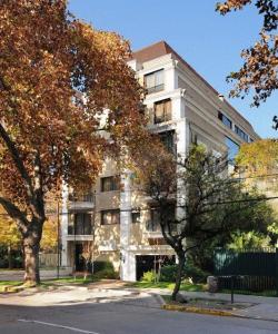an apartment building with trees in front of it at Park Plaza Apartments in Santiago