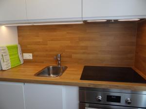 a kitchen with a sink and a wooden counter top at Apartment Birkenstrasse 52 Wohnung 2 by Interhome in Engelberg