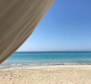 a view of the ocean from a tent on the beach at Gallipoli Mancaversa Futura Vacanza Andrea in Marina di Mancaversa