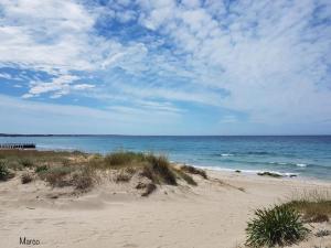 a sandy beach with the ocean in the background at Gallipoli Mancaversa Futura Vacanza Andrea in Marina di Mancaversa